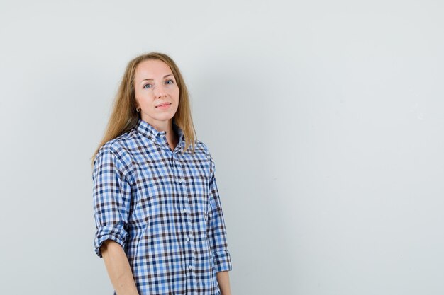 Blonde lady looking at camera in shirt and looking sensible.