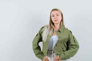 Free photo blonde lady posing while standing in jacket, pants and looking cute , front view.