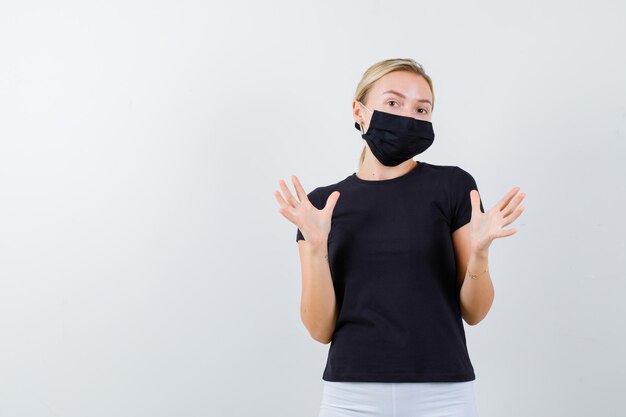 Blonde lady pretending to defend herself in black t-shirt