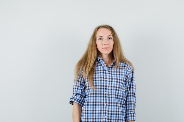 Blonde lady in shirt looking at camera and looking sensible ,