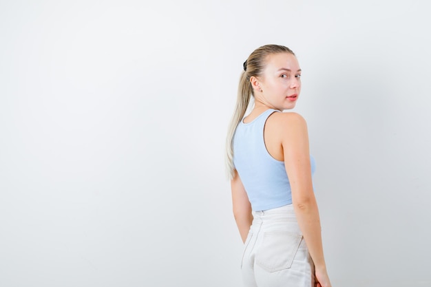 Blonde lady turnes her right side on white background