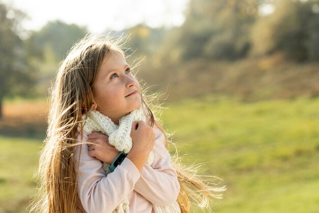 Blonde little girl looking away