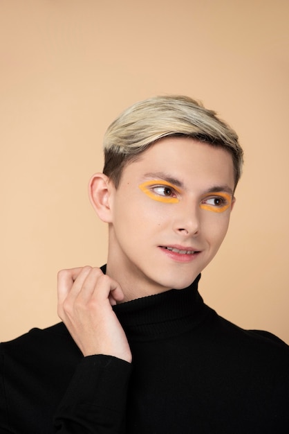 Free photo blonde man wearing make-up