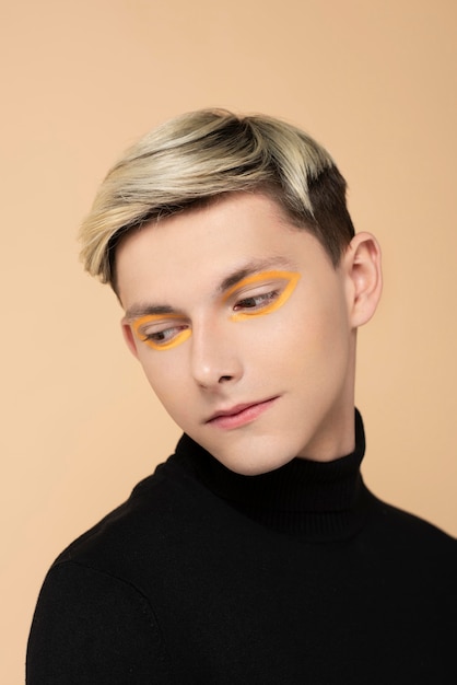 Free photo blonde man wearing make-up