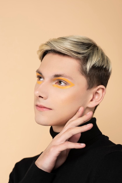 Free photo blonde man wearing make-up