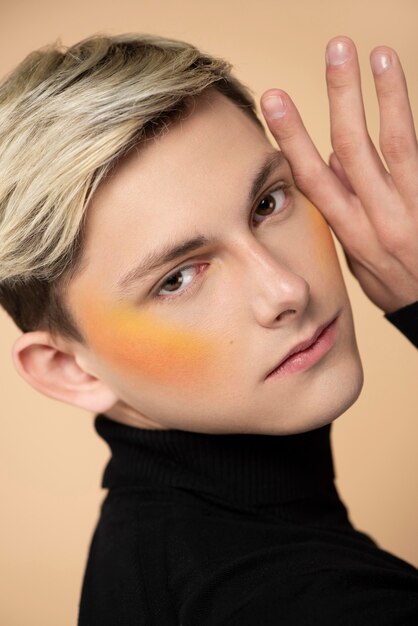 Free photo blonde man wearing orange blush