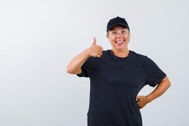 Blonde mature woman in a black t-shirt and a black cap