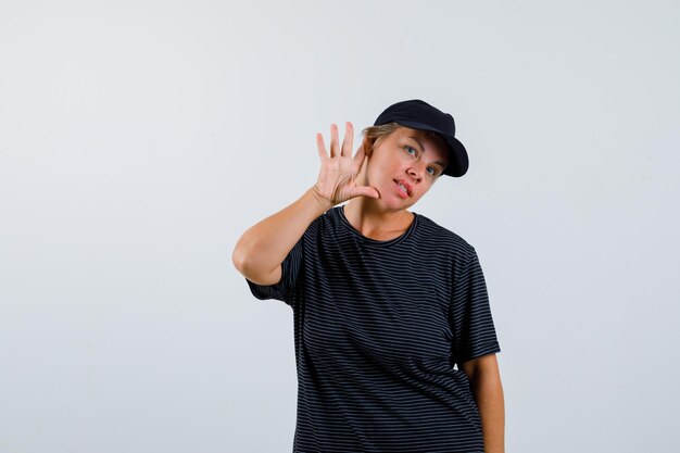 Blonde mature woman in a black t-shirt and a black cap