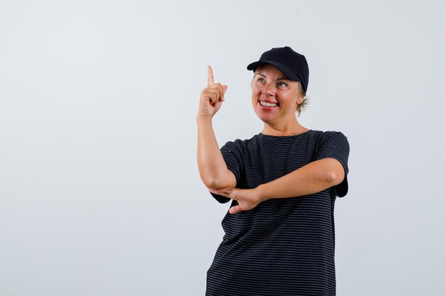 Blonde mature woman in a black t-shirt and a black cap