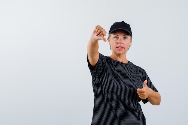 Blonde mature woman in a black t-shirt and a black cap