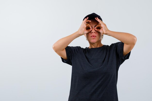 Blonde mature woman in a black t-shirt and a black cap