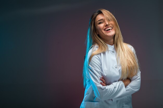 Blonde model in white shirt looks seductive and positive. 