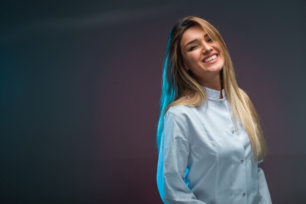 Blonde model in white shirt looks seductive and positive.