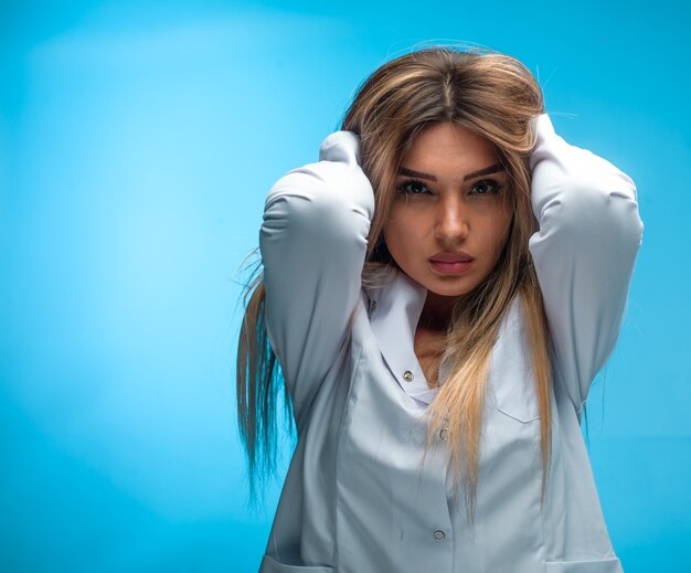 Blonde model in white shirt looks seductive . 