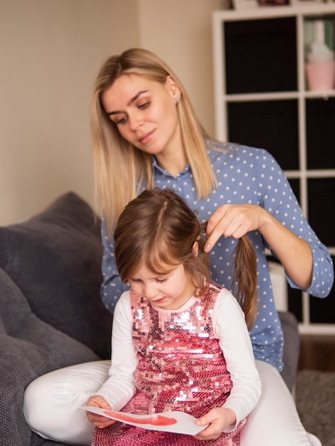 Blonde mother and young daughter together