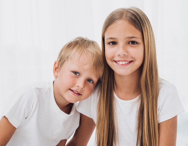 Blonde siblings looking at the camera close-up