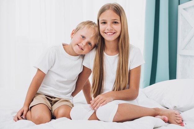 Blonde siblings looking at the camera