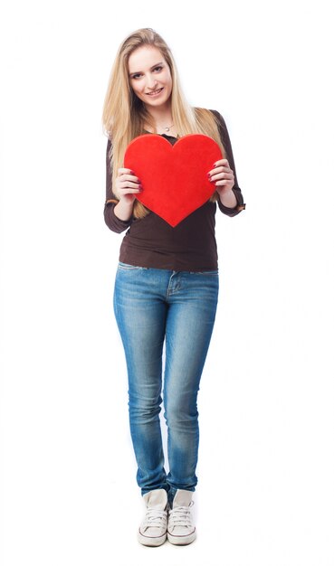 Blonde teenager holding a big heart