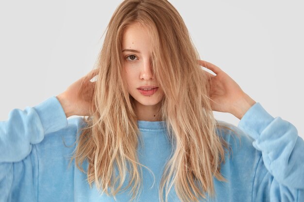 Blonde woman in blue shirt posing