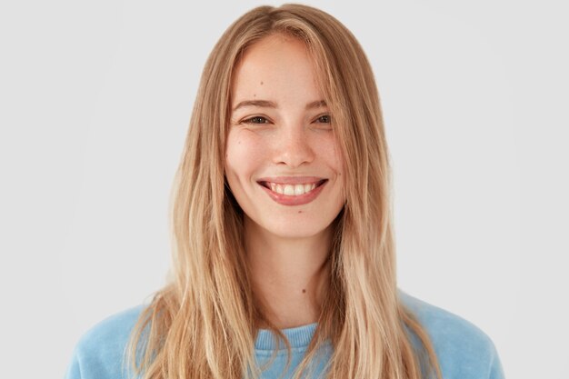 Blonde woman in blue shirt posing