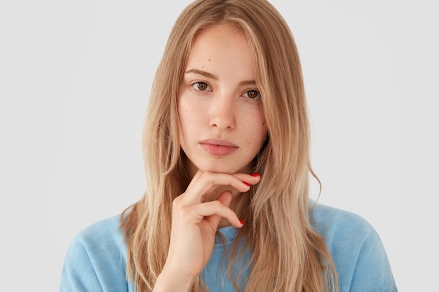 Blonde woman in blue shirt posing