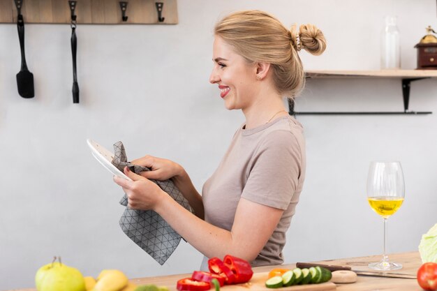 Blonde woman cleaning the plate