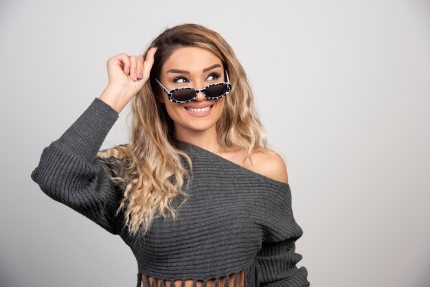 Blonde woman in eyeglasses feeling happy. 