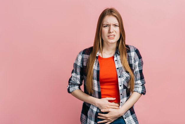 腹痛を持つブロンドの女性