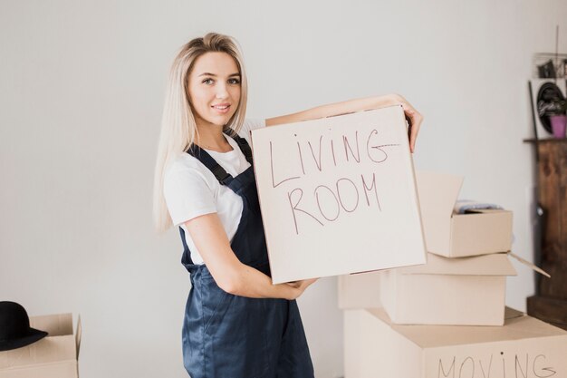 Blonde woman holding carton box