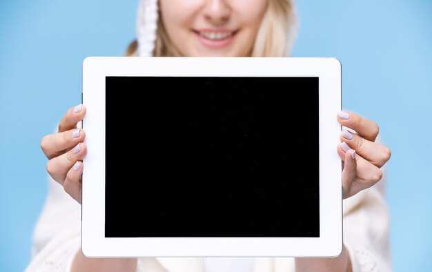 Blonde woman holding a tablet with mock-up