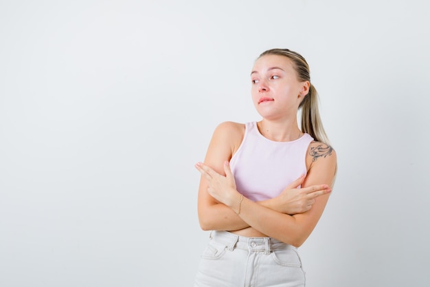 Blonde woman is shooting both sides on white background