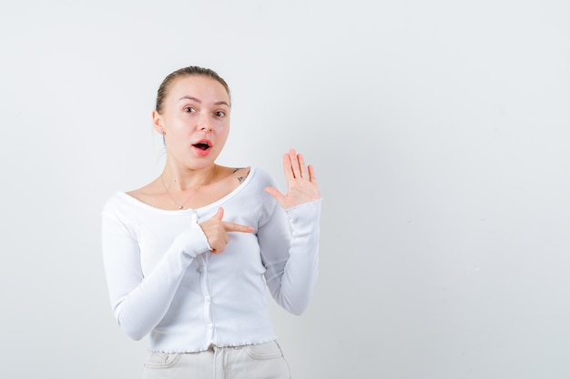 Blonde woman is showing her right side on white background