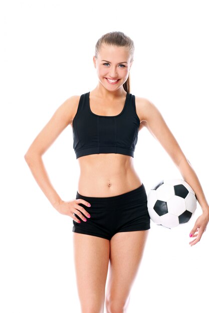blonde woman posing with football