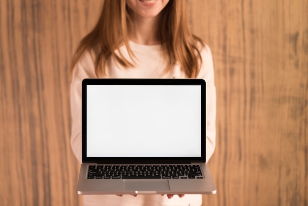 Foto gratuita donna bionda che mostra un computer portatile aperto