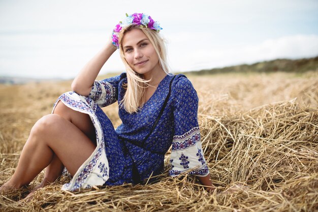 Blonde woman sitting in field