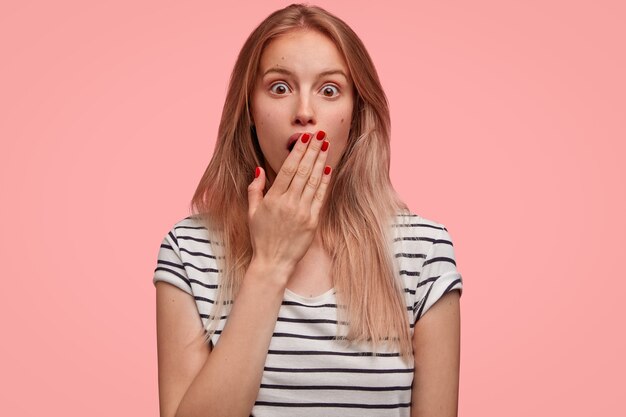 Blonde woman in striped shirt posing