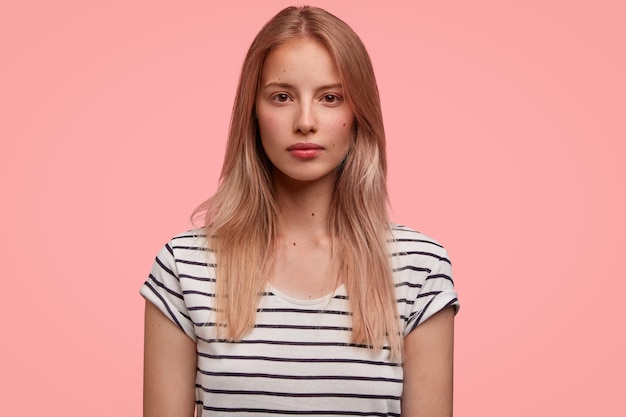 Blonde woman in striped shirt posing