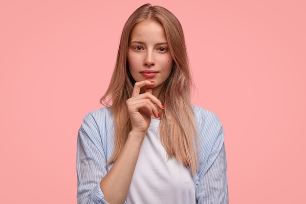 Blonde woman in striped shirt posing