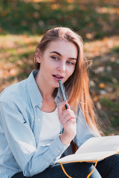 Blonde woman thinking what to write