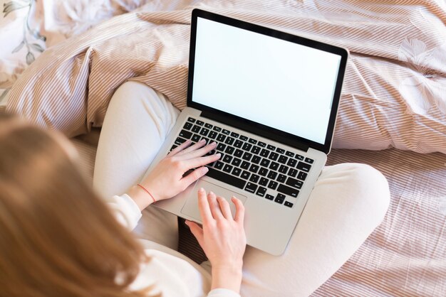 Blonde woman using her laptop