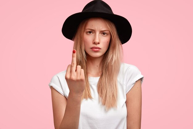 Blonde woman wearing big hat and casual T-shirt