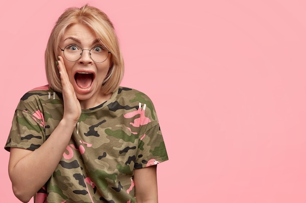 Blonde woman wearing camouflage T-shirt