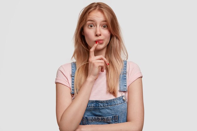 Blonde woman wearing denim overalls