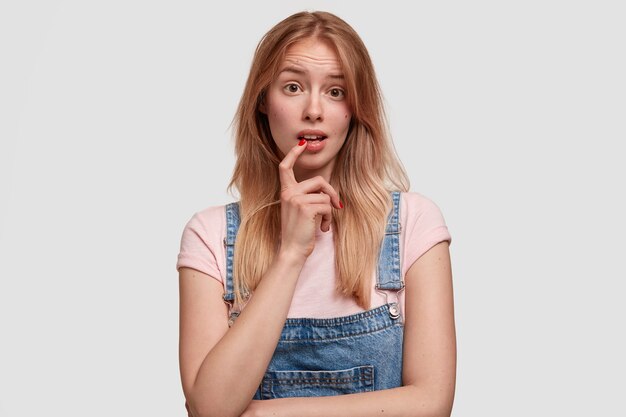 Blonde woman wearing denim overalls