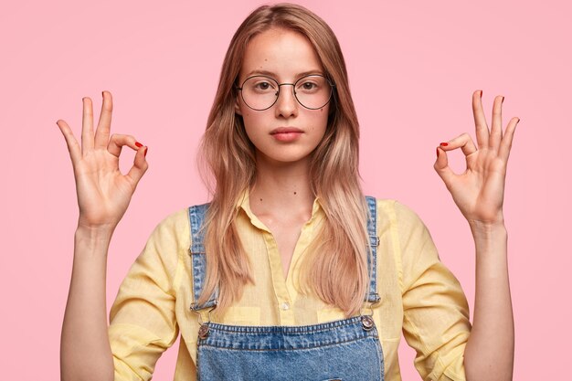 Blonde woman wearing denim overalls