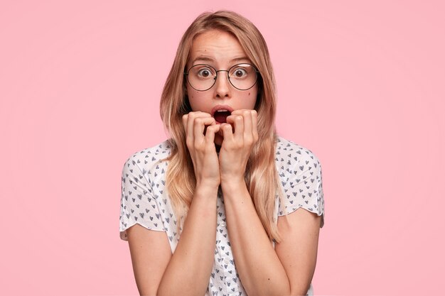 Blonde woman wearing dotted shirt and eyeglasses