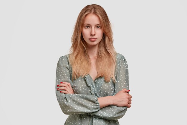 Blonde woman wearing polka dot blouse