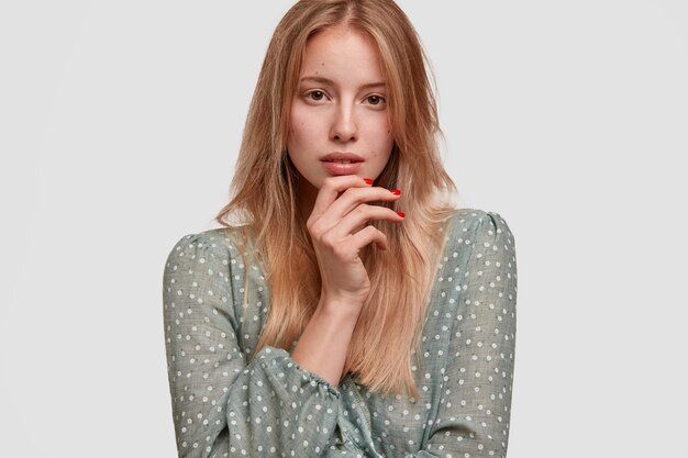 Blonde woman wearing polka dot blouse