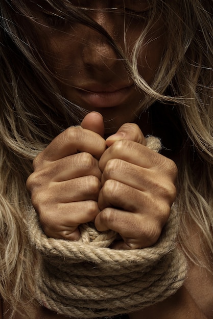 Free photo blonde woman with hands tied