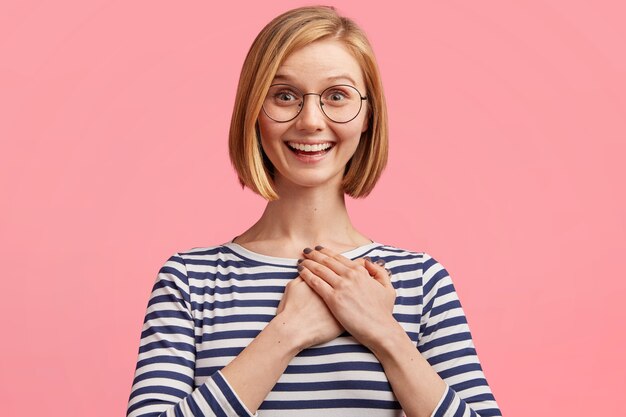 Blonde woman with round glasses and striped blouse